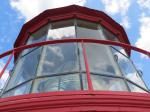 The top of the lighthouse with the Fresnel lens visible inside